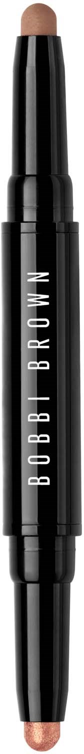 A double-ended makeup pencil from Bobbi Brown, likely a concealer or highlighter, with a black handle and beige product at both ends.