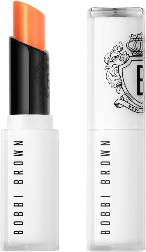 A lipstick and its clear case with black and white Bobbi Brown branding. The lipstick is orange and slightly pointed.