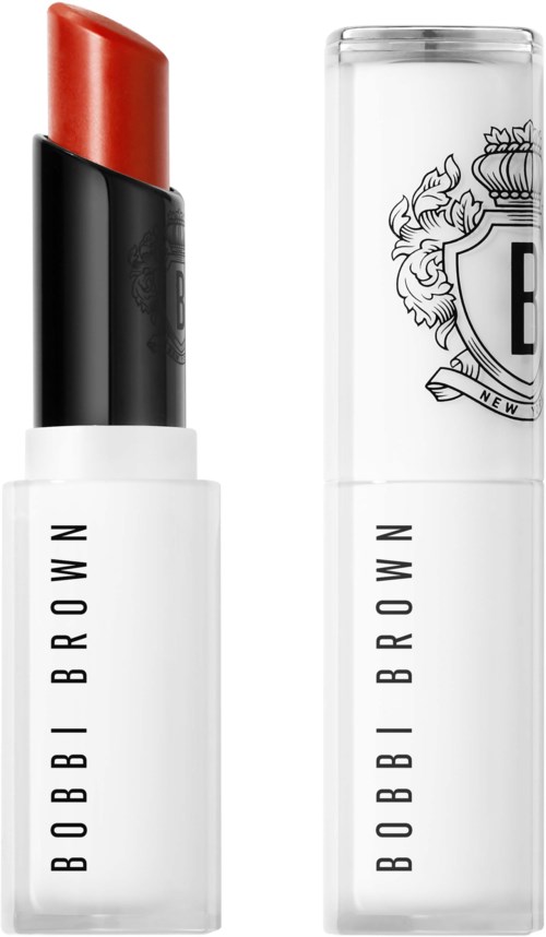 A lipstick tube with red lipstick and a clear, decorated cap with a logo. The brand name is Bobbi Brown.