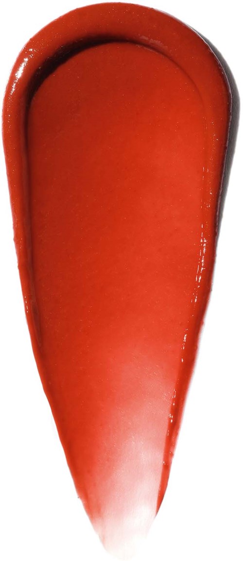 A red, elongated, teardrop-shaped object with shiny surface. It appears to be a splash of paint or sauce.