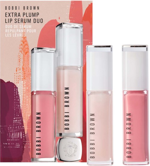 Four lip serum bottles with pink shades, branded 'Bobbi Brown,' arranged in front of a pink and orange background.
