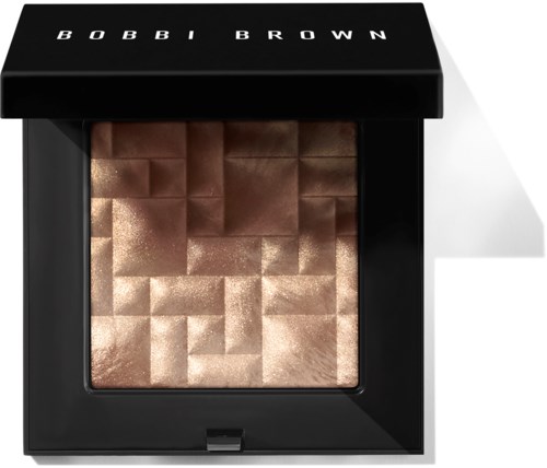A square makeup compact with shimmering, pixelated bronze and gold powders, labeled 'BOBBI BROWN'.
