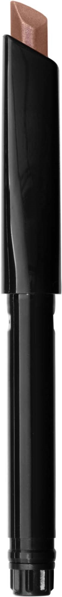 A makeup stick with a black body and a beige tip, likely a concealer or foundation stick.