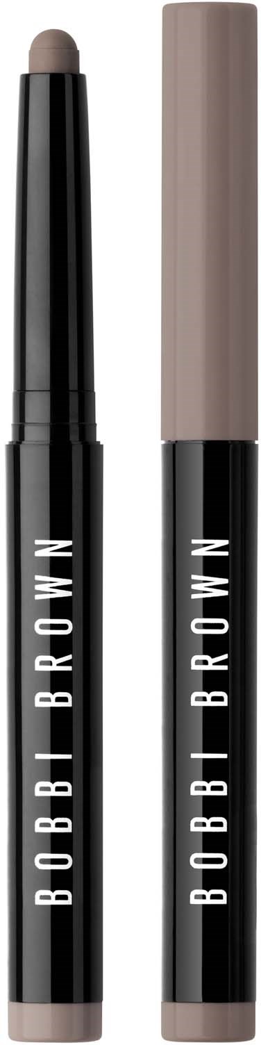 Two Bobbi Brown makeup sticks, one opened showing a beige product, the other closed. Black and beige packaging.