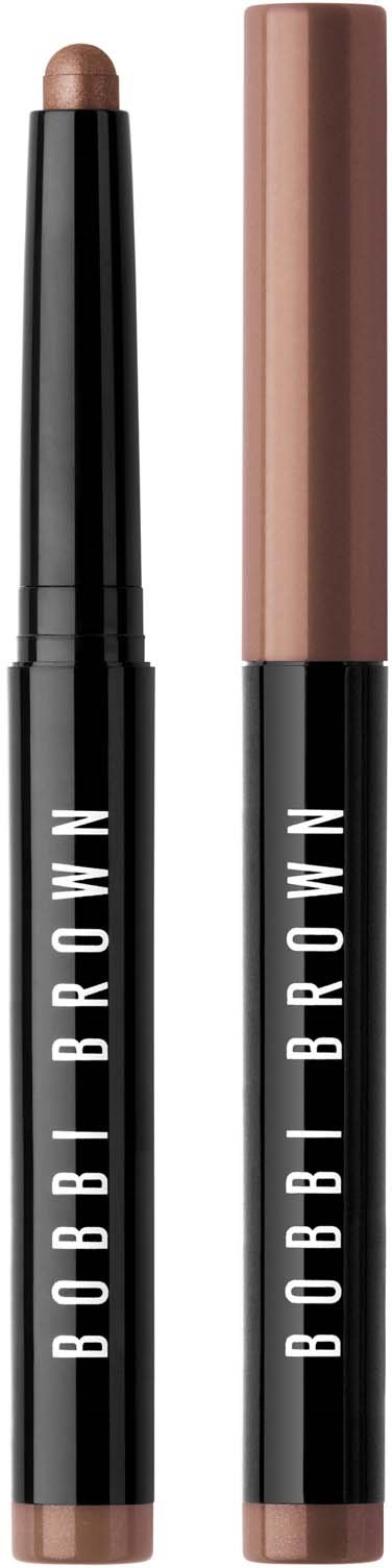 Two makeup sticks, one with a beige shade and one with a brownish shade, both labeled 'BOBBI BROWN' on black handles.
