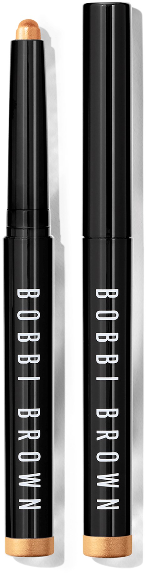Two black and gold Bobbi Brown makeup sticks with caps, one with the lid off showing the product.