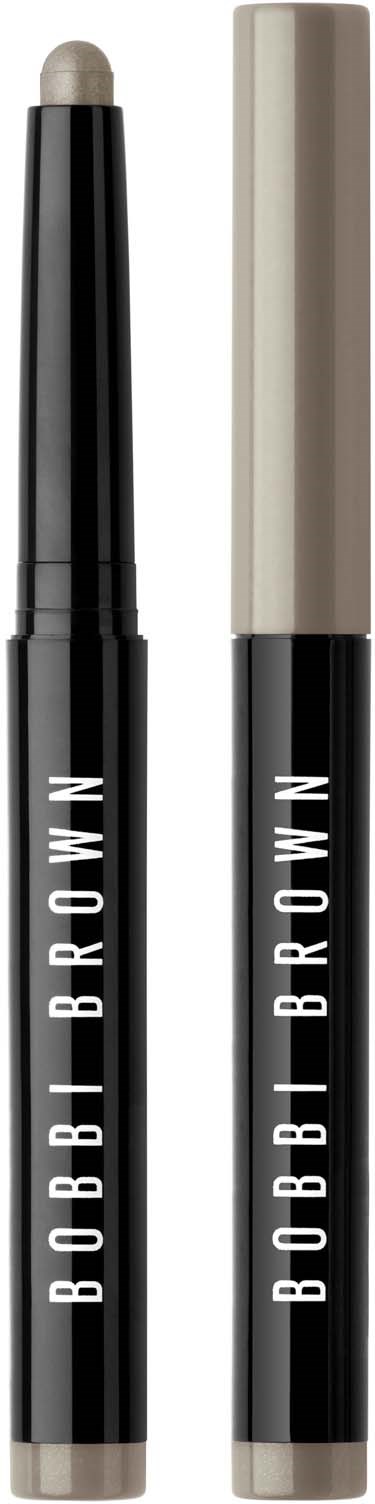 Two Bobbi Brown makeup sticks, one with a beige cap and the other open showing a cream-colored product.