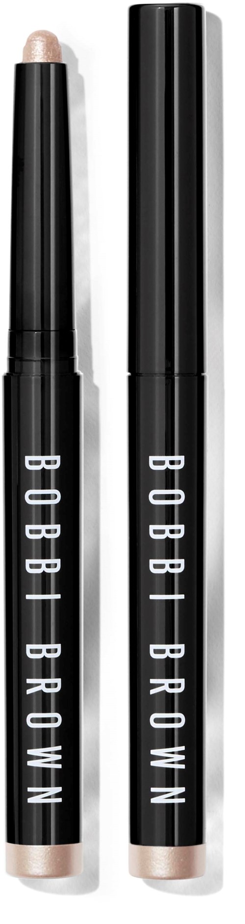 Two Bobbi Brown concealer sticks, one with cap off revealing light beige product, and the other with cap on.