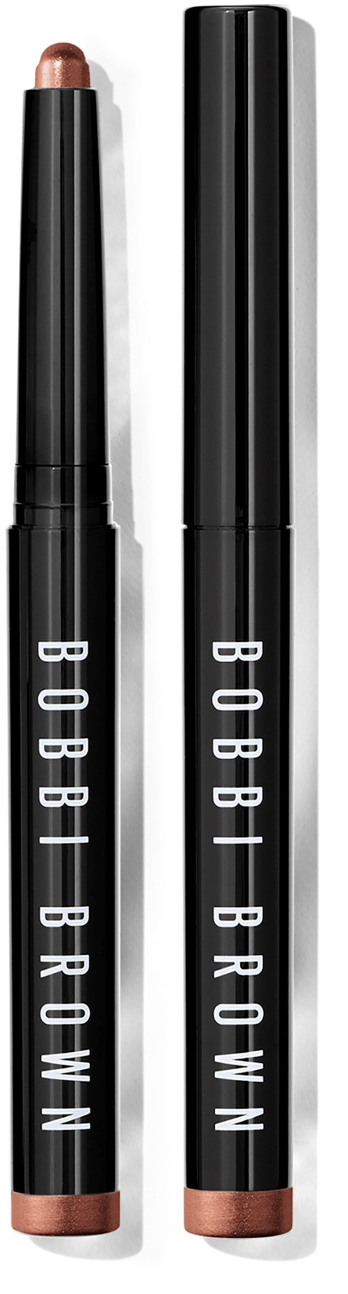 Two Bobbi Brown eye crayons, one with the cap on and one with the cap off showing the tip.