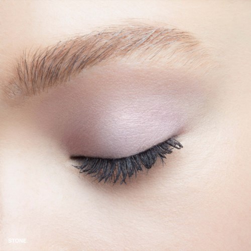 Close-up of a closed eye with long eyelashes and light eyeshadow.