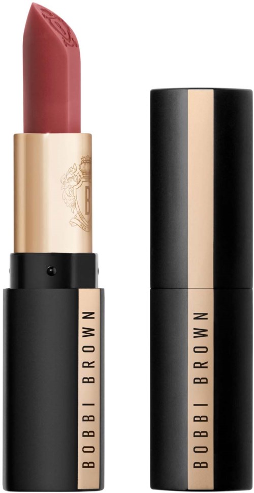 Ein neutraler Lippenstift mit Gold- und Schwarztube und Markenname Bobbi Brown. Der Lippenstift ist teilweise ausgefahren.