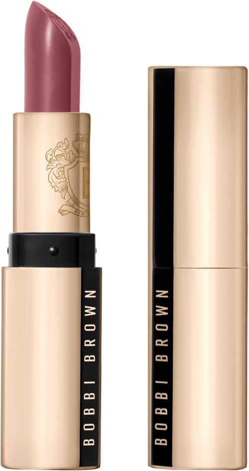 A lipstick with a gold and black tube, showing a pinkish brown color.