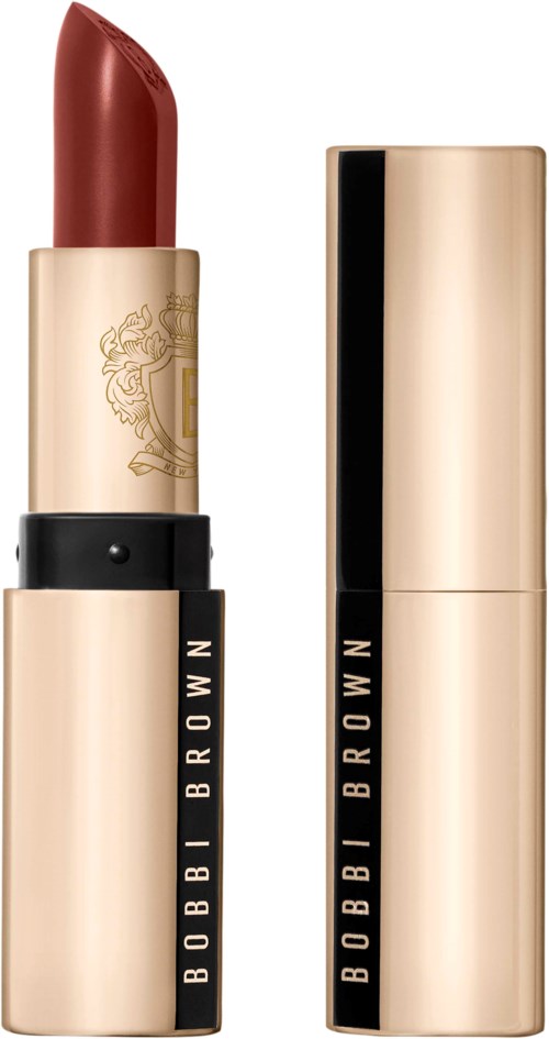 A lipstick with a gold and black tube, uncap reveals a red lipstick stick.