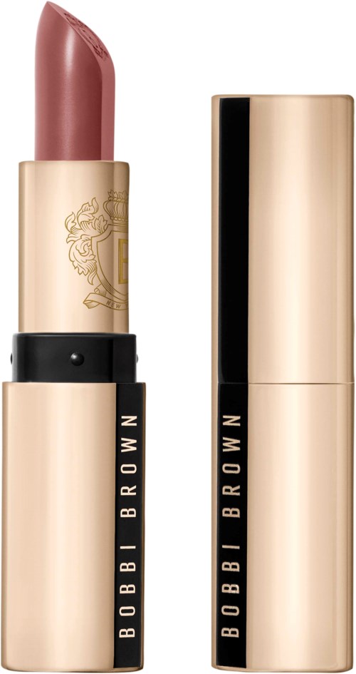 A lipstick in a pinkish hue with a gold and black case, with the cap removed showing the lipstick.