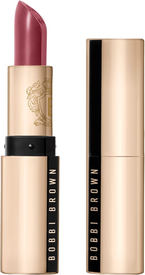 A pink lipstick in a gold and black case, with the cap removed showing the lipstick.