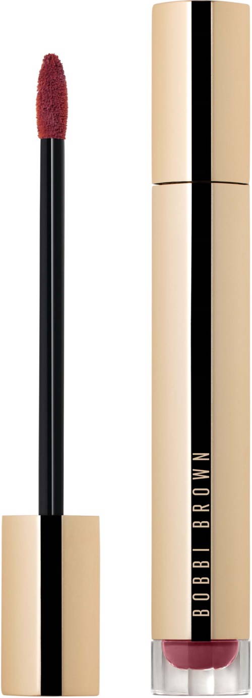 A lipstick with a gold body and a black middle, showing the applicator with red lip color. Bobbi Brown logo on the tube.