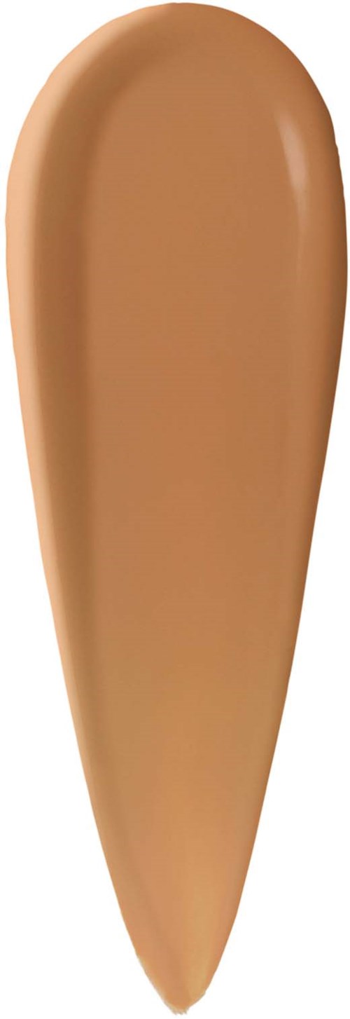 En beige flytande bas för smink på vit bakgrund.