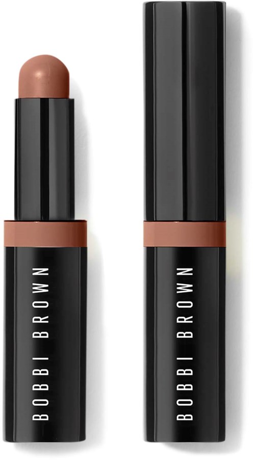 A Bobbi Brown lipstick with a nude shade, open on one end and closed on the other.