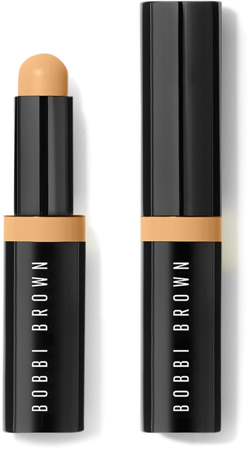A black lipstick tube with a beige-colored lipstick and a separate black cap. The tube has text 'BOBBI BROWN' on it.