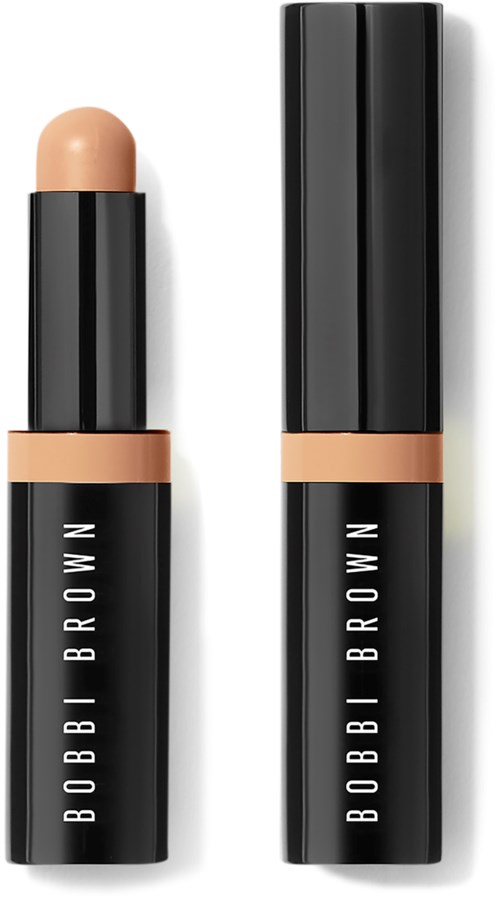 A black tube of Bobbi Brown cream stick with beige cap, the cap removed shows the product inside.