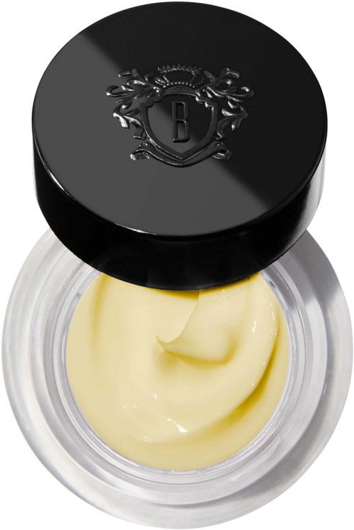 Ein Behälter mit weißer Creme und einem schwarzen Deckel mit Emblem.