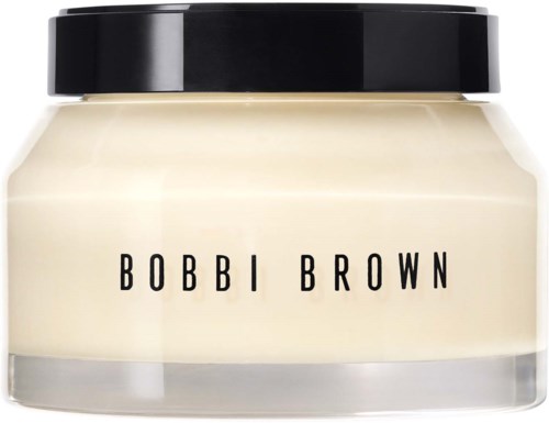 A cosmetic jar with a black lid and white cream inside, labeled Bobbi Brown.