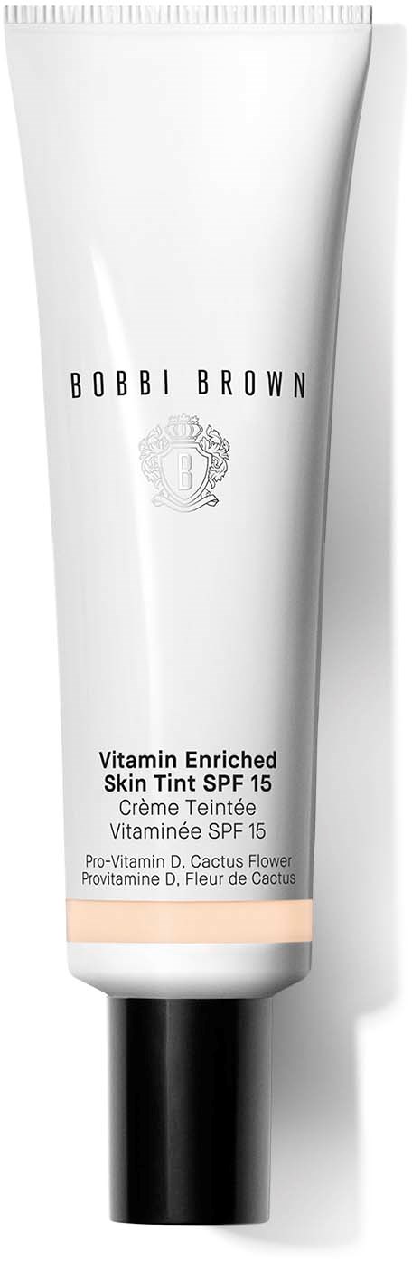 A white tube with black cap, labeled 'Robbi Brown, Vitamin Enriched Skin Tint SPF 15, Creme Teintée.'