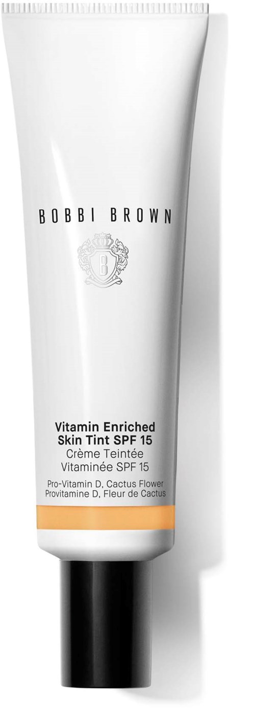 A white tube of Bobbi Brown Vitamin Enriched Skin Tint with SPF 15, orange detail, black cap.