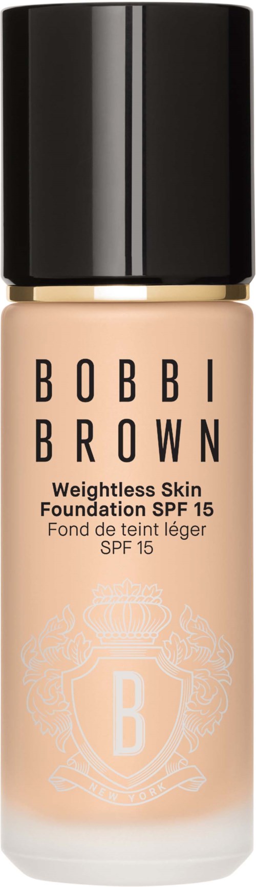 A foundation bottle with a black cap, beige liquid inside, and name 'Bobbi Brown' on it.