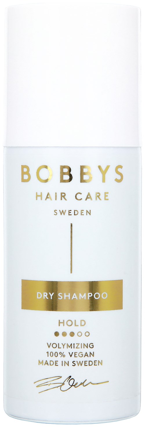 Een witte fles met het label 'Bobbys Hair Care Sweden' met goud en zwart text voor droogshampoo, vegan en gemaakt in Zweden.