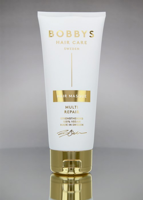 En vit tub med Bobby's Hair Care hårinpackning med gulddetaljer, märkt 'Multi Repair' för stärkning och återhämtning.