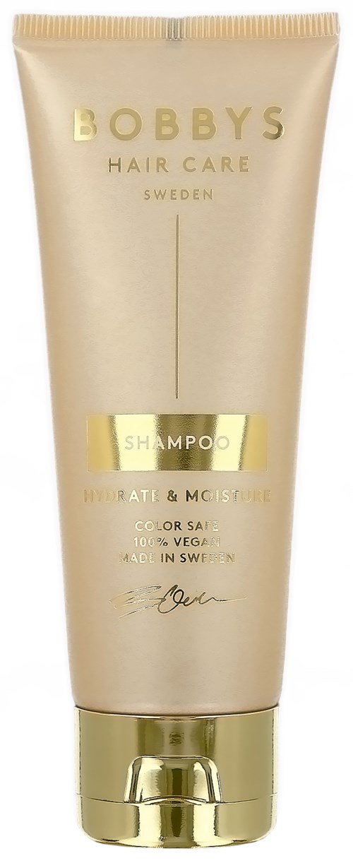 Eine goldene und cremefarbene Tube mit Bobby's Hair Care Shampoo, mit Text und Logo, steht aufrecht.