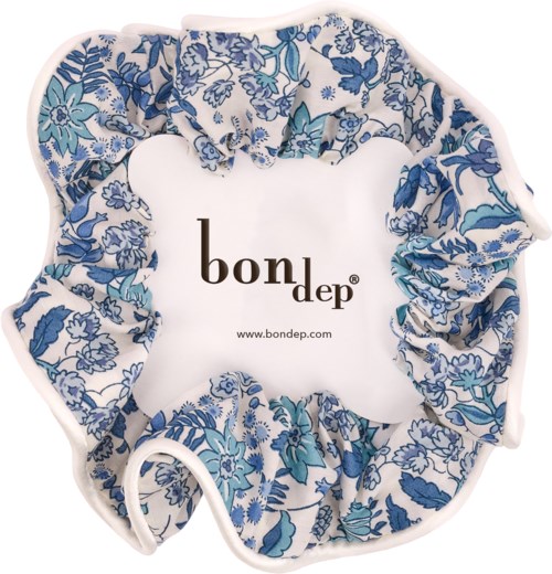 A floral patterned fabric scrunchie surrounds a white square with the words bondep and website. Typical hair accessory design.