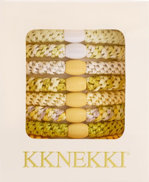 A set of woven bracelets with soft yellow beads, arranged in a box with the brand name KKNEKKI below.