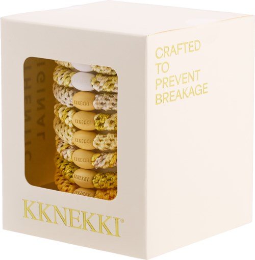 Box with yellow and white assorted snacks or biscuits, labeled KKNEKKI, with a window showing the contents.