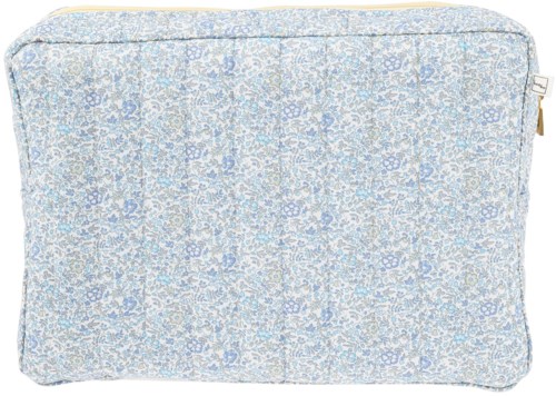 A soft, light-colored fabric with a small floral pattern, looks like a cushion cover or pillowcase.