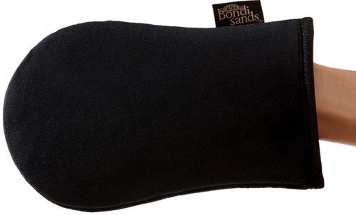A black oven mitt with a tag, covering a hand, made of soft fabric for heat protection.