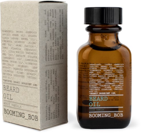 Eine kleine dunkelbraune Flasche mit schwarzem Deckel und blauer und weißer Schrift, neben einer schlichten weißen Box.
