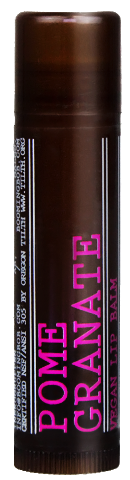 Ein brauner Stick mit pinkem und weißem Text, der "POME GRANNAT" und "HYDRATING LIP BALM" sagt.