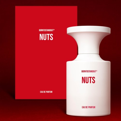 Een witte parfumfles en een rood doosje met witte en rode tekst, gelabeld 'NUTS' door Born To Stand Out.