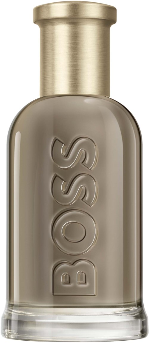 Eine Glasflasche mit goldener Kappe und dem Wort BOSS eingraviert. Wahrscheinlich Parfüm oder Eau de Cologne.