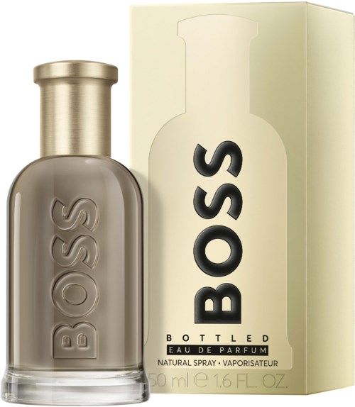 Ein Parfümflasche und Schachtel mit dem Wort BOSS, beige und goldfarben, schlichtes Design.