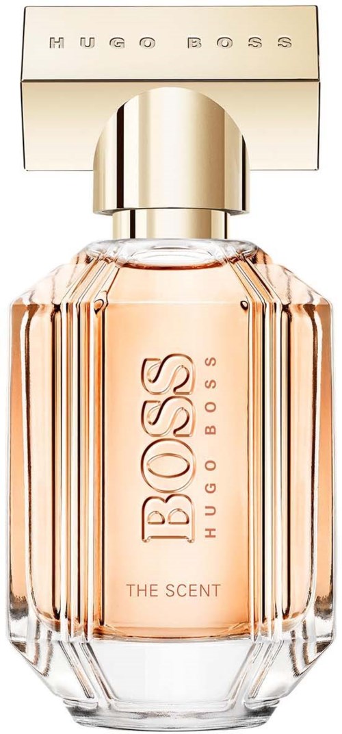 En parfyllf bottle med klar, ribbad glasdesign, ljusrosa vätska inuti och ett beige lock med 'Hugo Boss' på toppen.