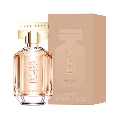 En flaska Hugo Boss-parfym med rosa liknande vätska, guld- och krämfärgad etikett och matchande förpackning.