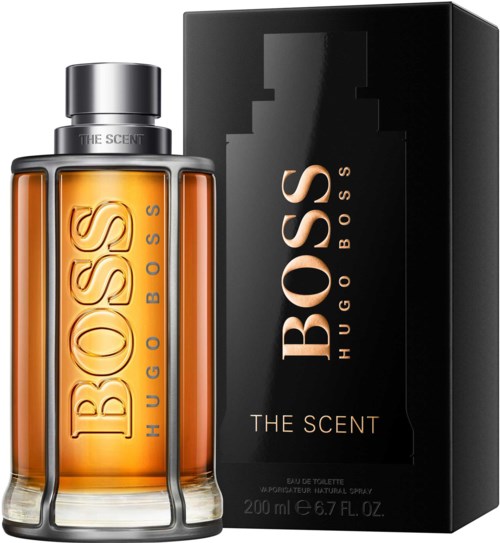 En doftflaska av Hugo Boss The Scent med svart box, orange vätska, silverlock, och stor fet logga.