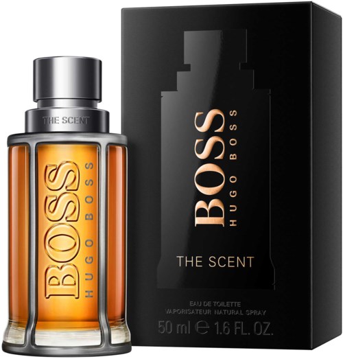 Een parfumfles met oranje vloeistof en een zwarte doos met 'Boss The Scent' door Hugo Boss.