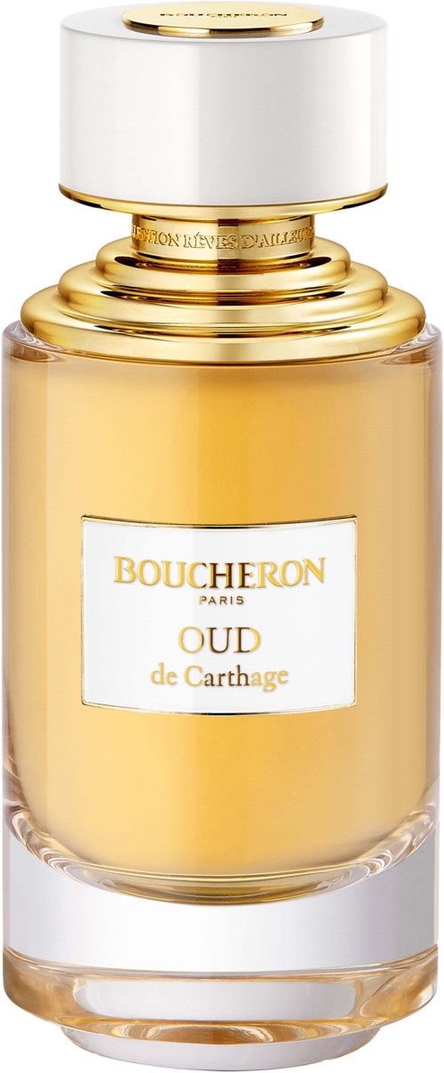 A perfume bottle with a white and gold cap, labeled 'Boucheron Oud de Carthage,' contains golden-colored perfume.