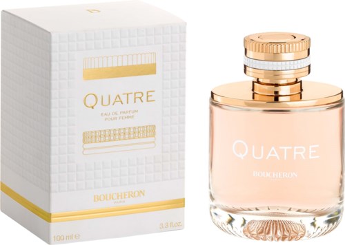 A perfume bottle and box labeled "Quatre" by Boucheron, with gold and pink design elements.