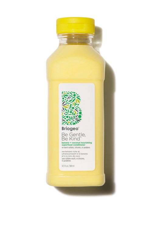 Gele fles met Biogeo-conditioner met een groen en geel bladerenontwerp label, hoofdtekst zegt "Wees Zacht, Wees Vriendelijk."