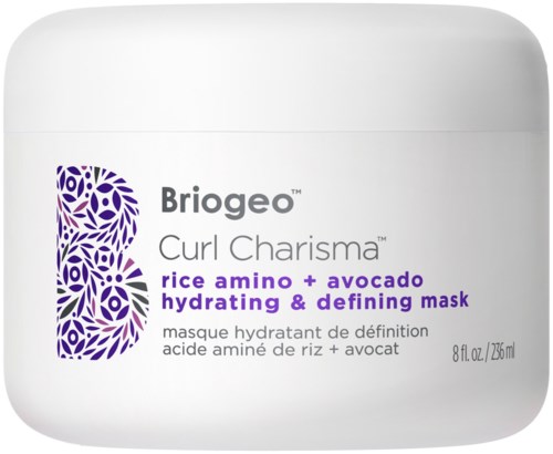 Een witte pot met paarse en grijze tekst, vermeldt een haarmasker met rijstaminozuren en avocado voor hydratatie en definitie.